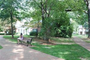 Senior Amanda Gross relaxes in front of Holland House before heading to her next class. The sociology building used to be to the right of the building before it was moved to accommodate the William Henry Belk Pavilion, which is currently there.